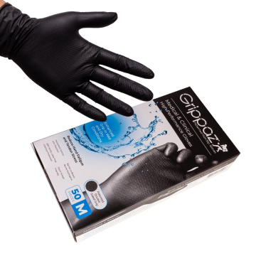 Black nitrile Grippaz glove on hand above box of 50 high performance non-slip gloves.